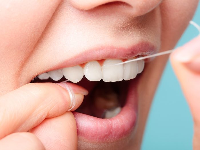 Oral,hygiene,and,health,care.,smiling,women,use,dental,floss