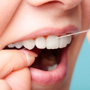 Oral,hygiene,and,health,care.,smiling,women,use,dental,floss