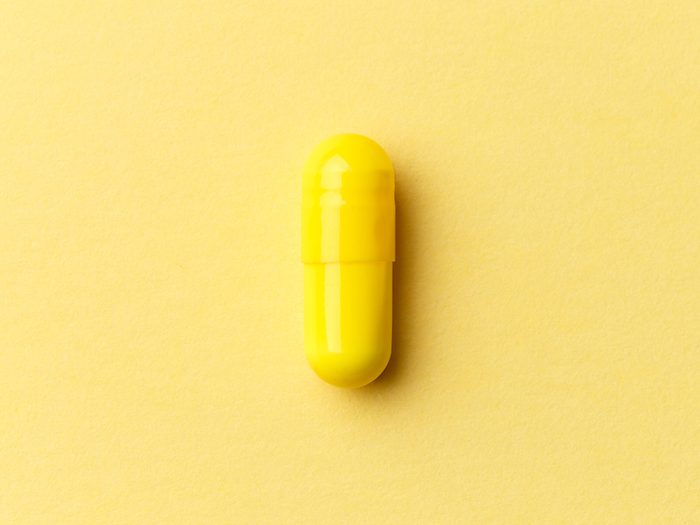 Pharmaceutical,medicine,pills,,tablets,and,capsules,on,colourful,yellow,background.