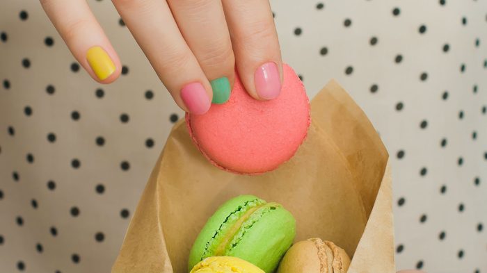cheat meals good, a woman holding macarons