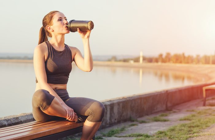maximize your workout_woman drinking protein shake