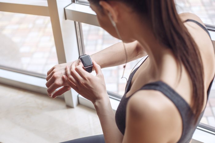 maximize your workout_woman checking watch