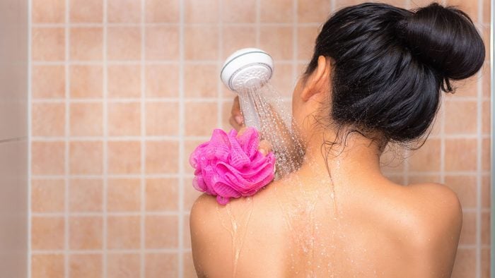 woman washing her shiny hair