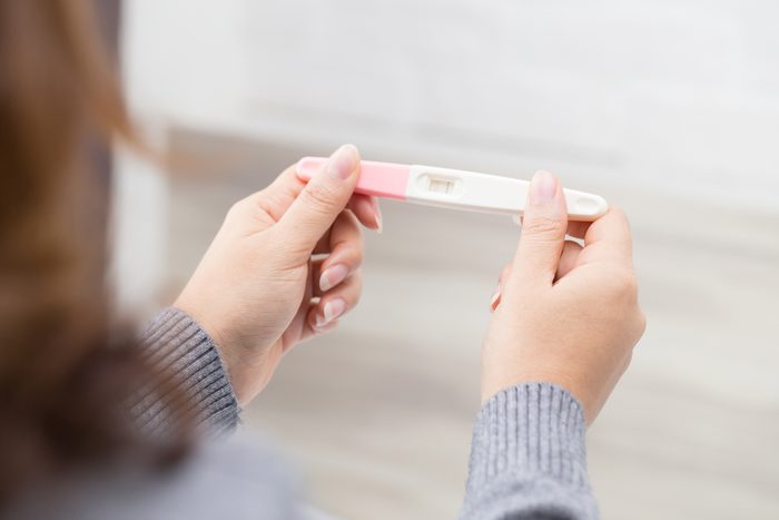 woman taking pregnancy test_always tired