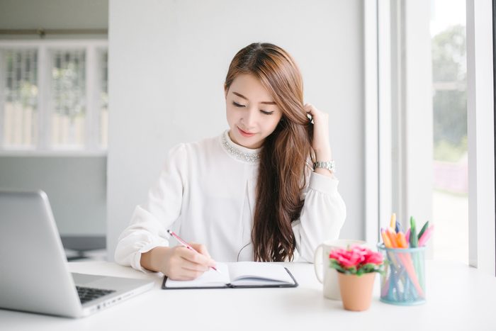 woman writing down goals