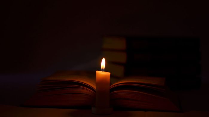 the history of the G Spot, a book with a candle
