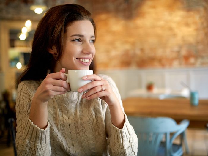 Caffeine, smiling woman drinking coffee