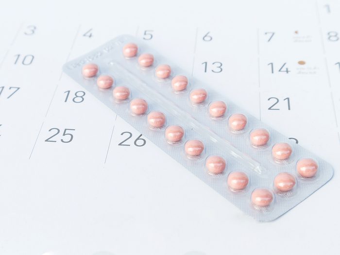 Gynecologist, birth control pill lying on a calendar