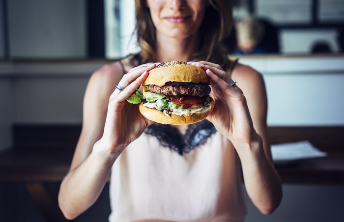 mental health facts _woman eating a hamburger