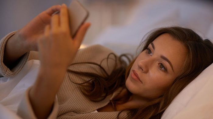 Texting, woman on smartphone in bed