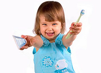 Toddler with a toothbrush and toothpaste