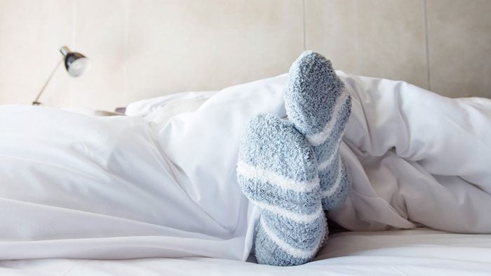 When to call in sick, woman in bed comfy