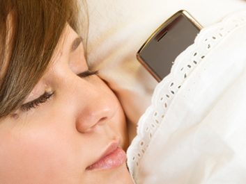 woman sleeping with cellphone