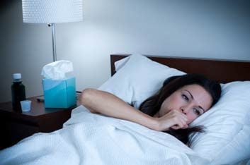 woman in bed with cough