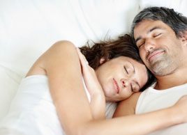 happy couple in bed sleeping