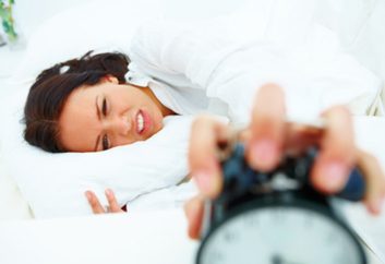 daylight savings time sleep woman tired clock alarm