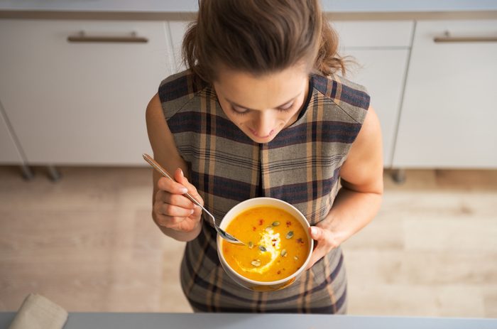 stay healthy during the holidays - woman eating soup
