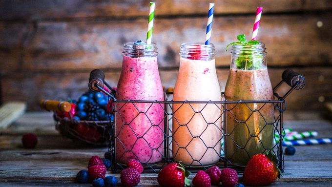 bright and colourful smoothies in milk jars