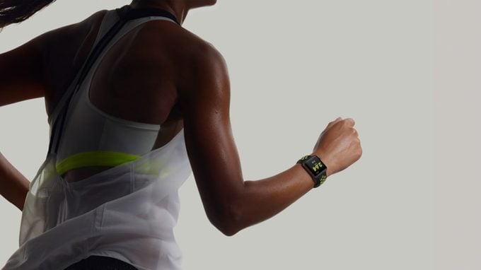 woman running with Apple Watch