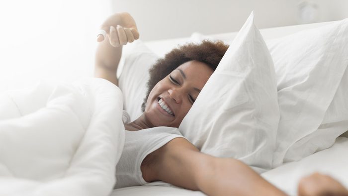 woman waking up, looking well rested