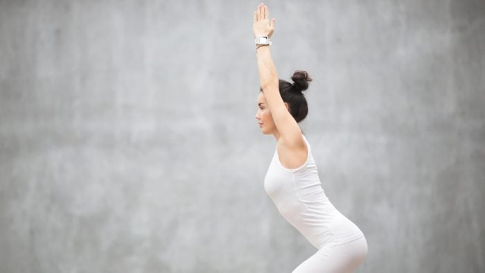 Woman with her hair up in a bun doing yoga