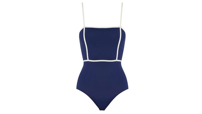 navy one piece suit with a contrasting white piped waistine and straps