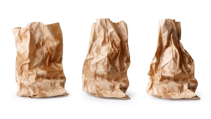 Three greasy, but mouth-watering paper bags with hopefully cronut burgers inside