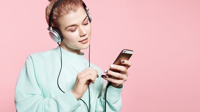Ruining hearing: young woman with headphones on