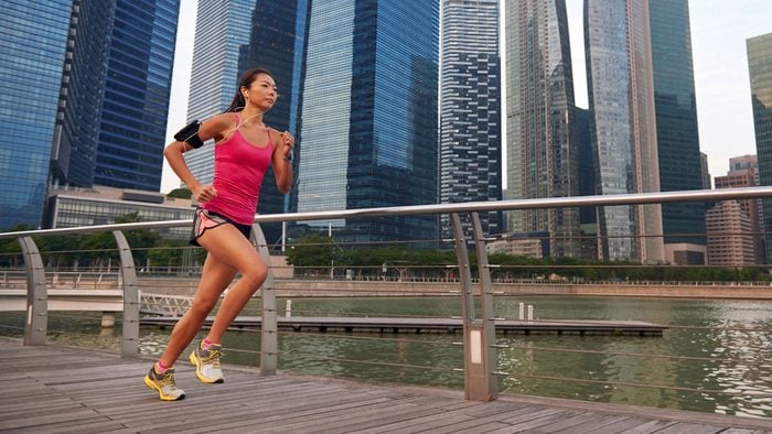 eat before a lunchtime run, a woman running near office buildings