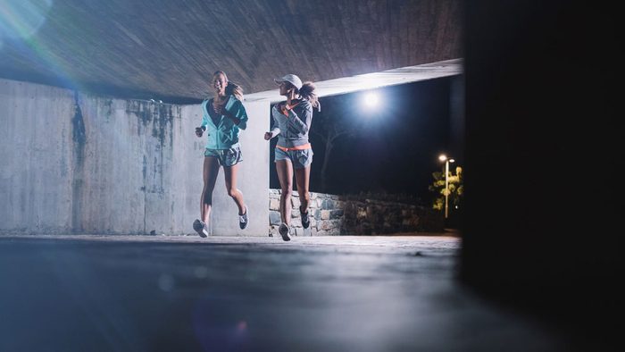 eat before a late night run, two women running under a bridge at night