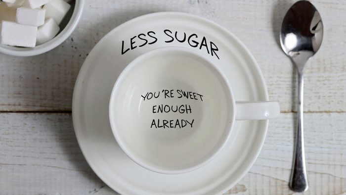 foods for a healthier heart, a tea cup with the words "less sugar, you're sweet enough" on the saucer and inside the cup