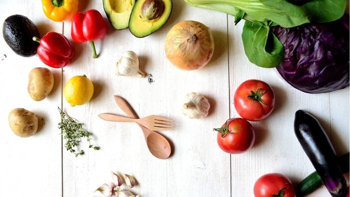 foods for a healthier heart, bright coloured veggies on a white cutting board