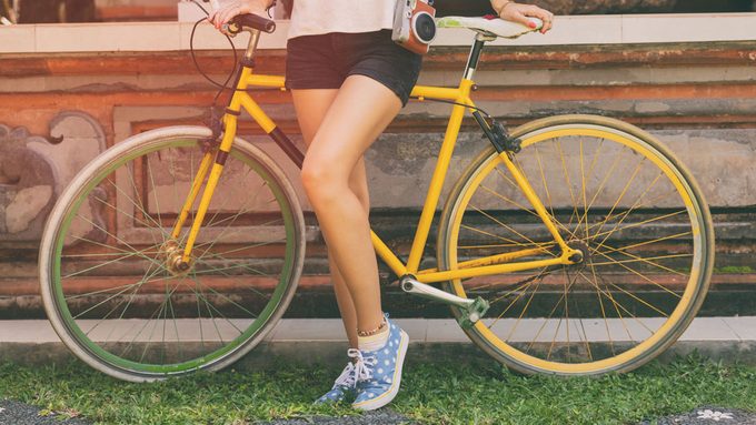 cellulite fixes, a woman in shorts hiding her legs