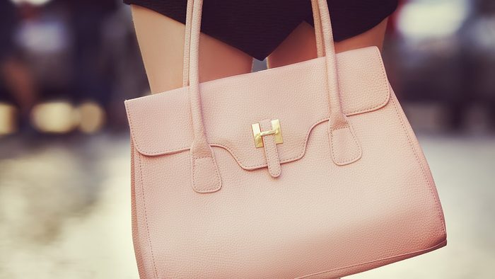 Fall wardrobe, woman holding pink leather bag