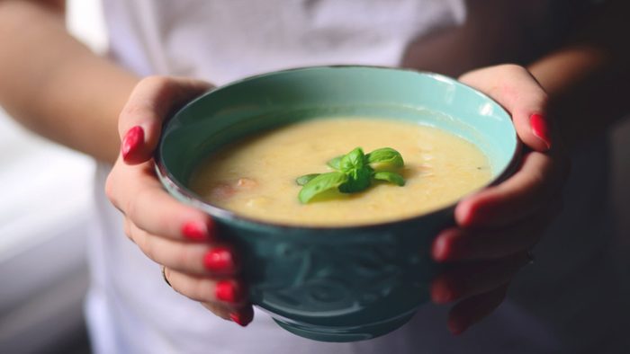 Weight loss tips, woman holding bowl of soup