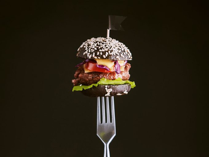 strict diet fail: a burger on a fork