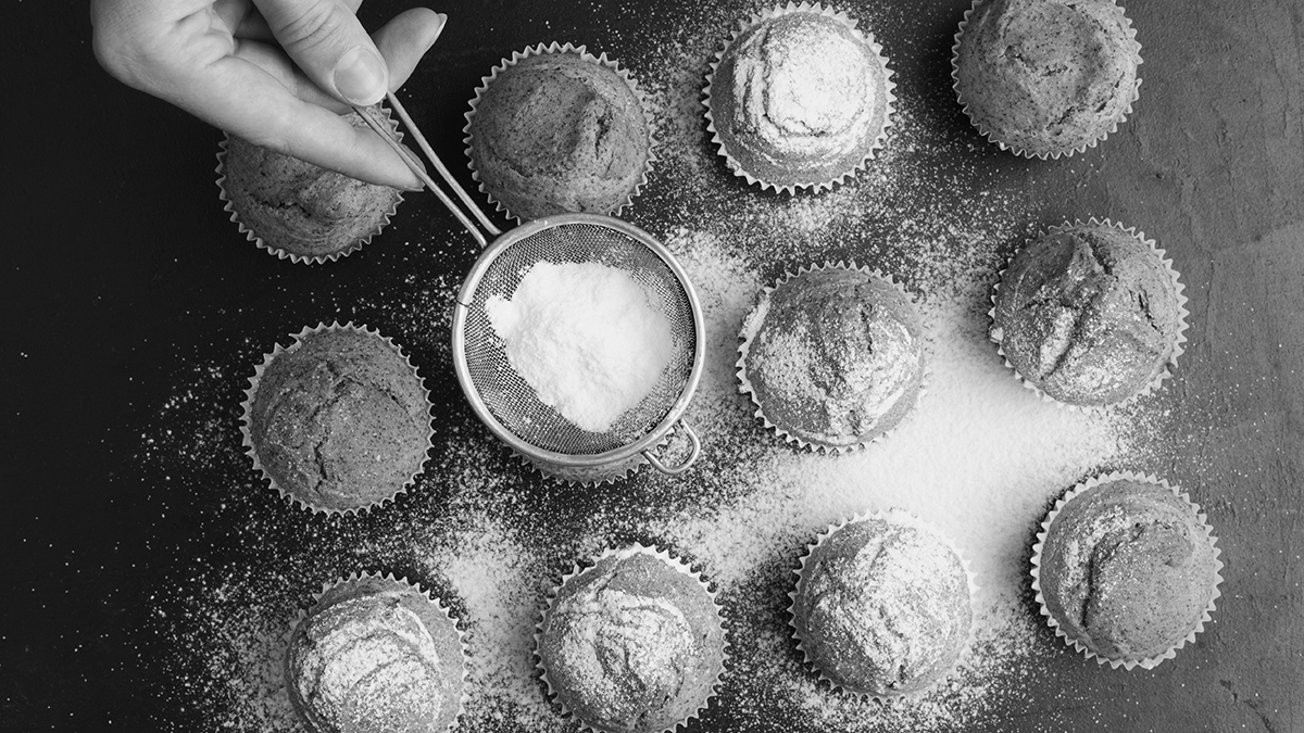 Cut back on sugar, powdered sugar being sprinkled on muffins