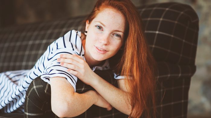 calm down now breathing technique, woman on couch smiling