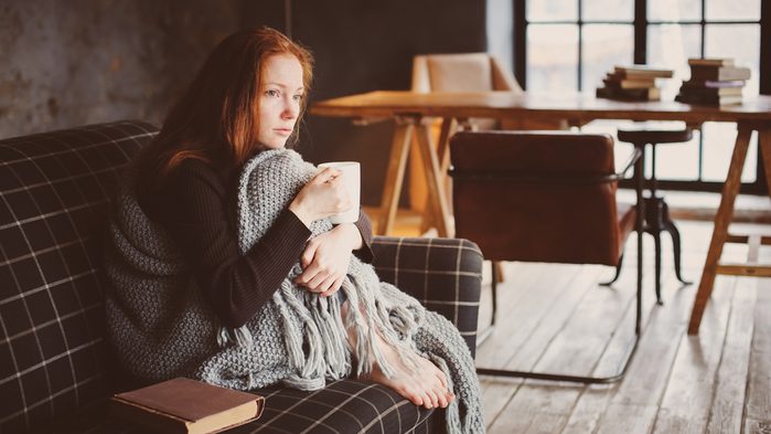 calm down now, woman on a couch looking nervous