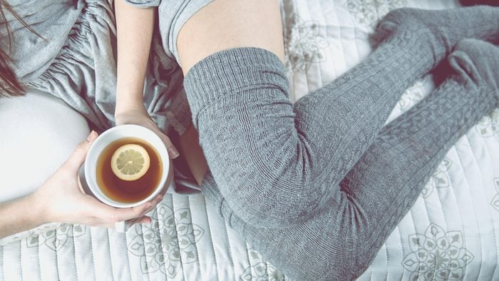 diet tips for sleeping, woman in bed with a cup of tea