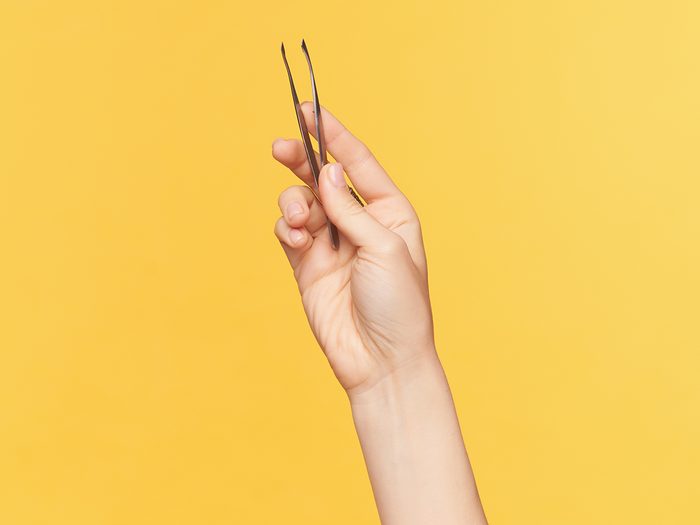 what to know if you pull out grey hairs | Studio,shot,of,young,female's,well Groomed,hands,keeping,tweezers,while