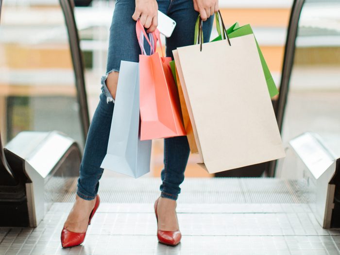 walk more avoid escalators, woman in a mall in front of escalators