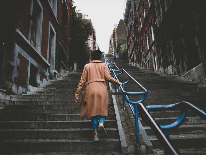 walk more walking wednedays, a woman walking up city stairs