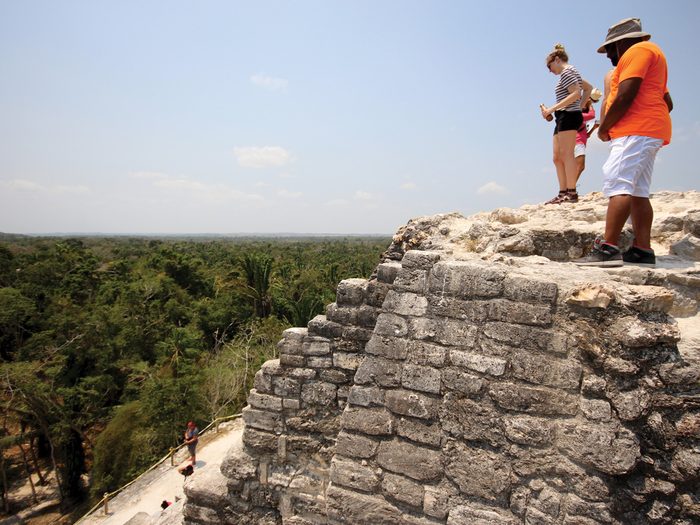 Belize Lamanai Ruins, Tourists looking over the Belize Lamani ruins