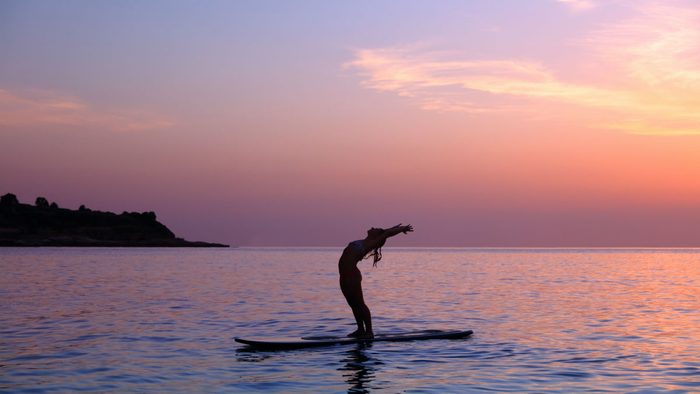 SUP yoga paddleboarding and yoga