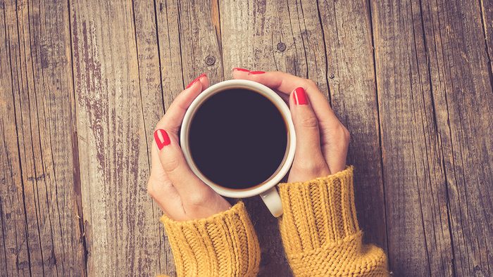 Coffee, woman holding her mug of coffee