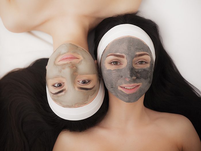 Blackheads, two women laying side by side wearing clay masks