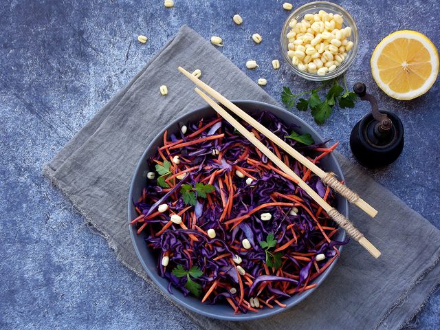 Cooking oil, red cabbage coleslaw with chopsticks