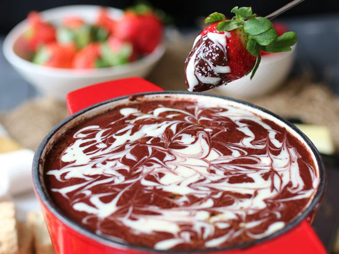Dessert, strawberry dipping into healthy red velvet fondue
