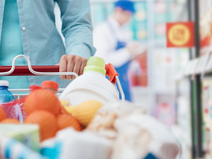 Healthy eating, Closeup of full grocery cart as woman shops at grocery store